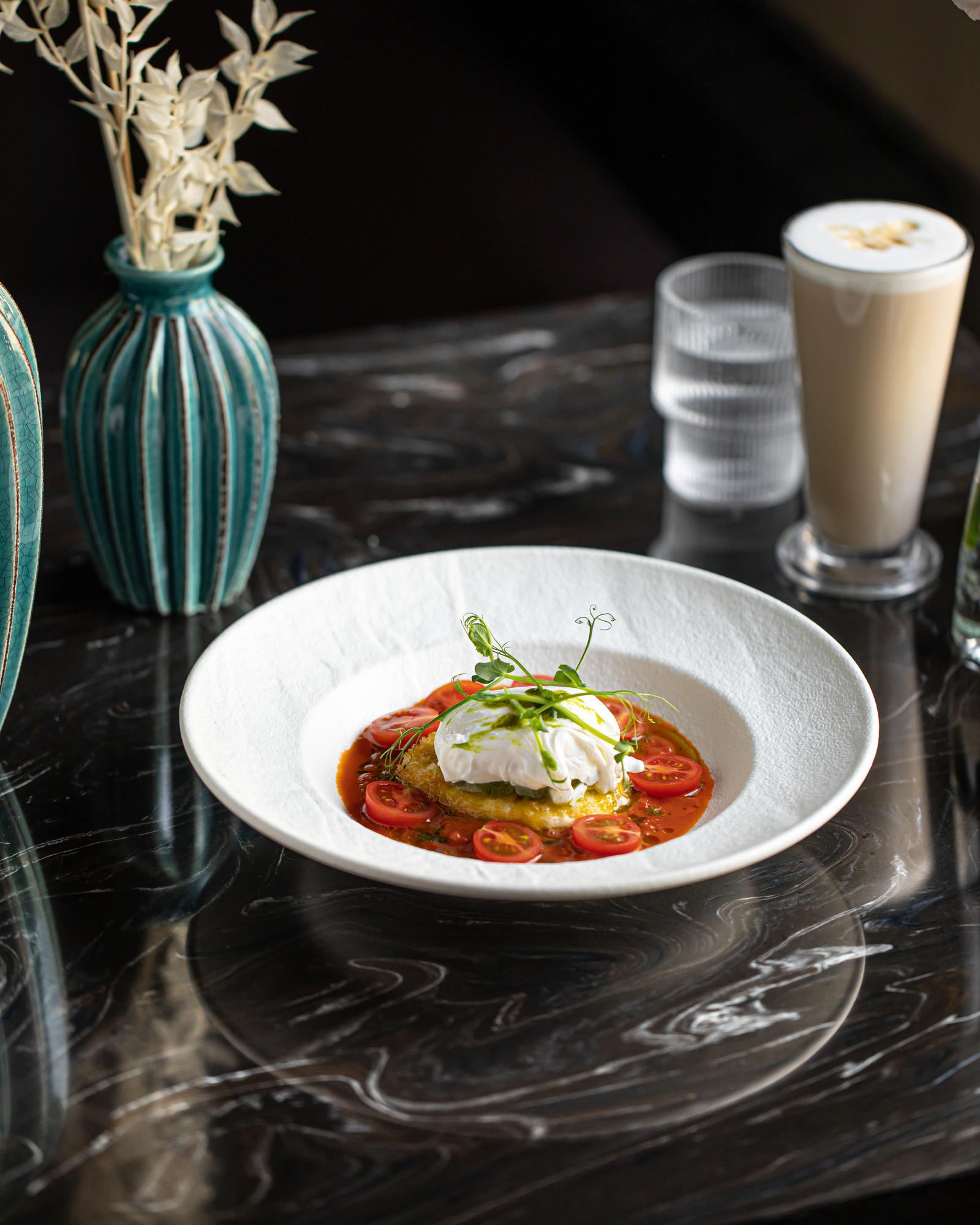 Plated gourmet entree on marble with minimal props